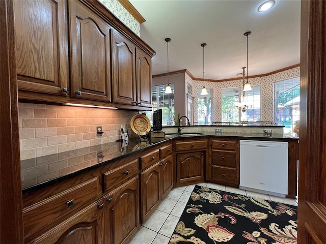 kitchen with crown molding, dishwasher, a sink, and wallpapered walls