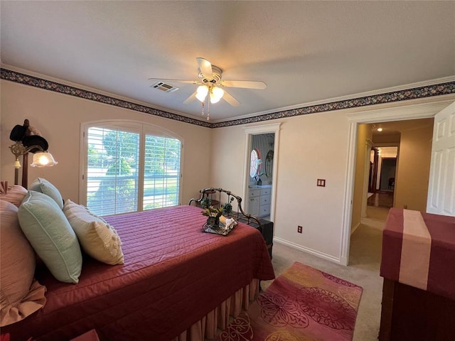 bedroom with baseboards, visible vents, connected bathroom, light colored carpet, and ceiling fan