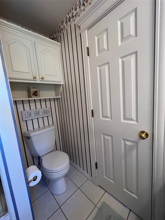 bathroom featuring tile patterned flooring and toilet