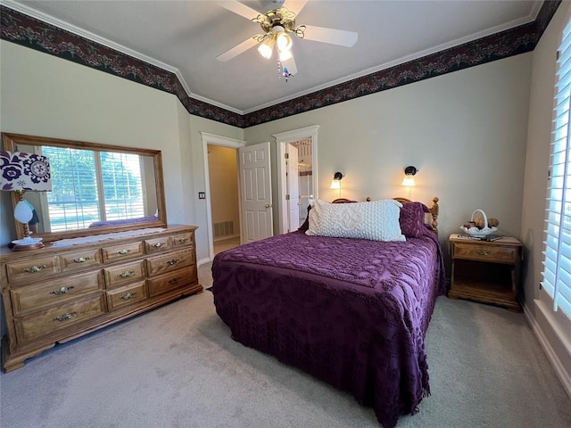 bedroom with a ceiling fan, carpet, visible vents, and crown molding