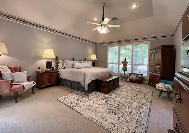 carpeted bedroom with ornamental molding, a tray ceiling, visible vents, and a ceiling fan