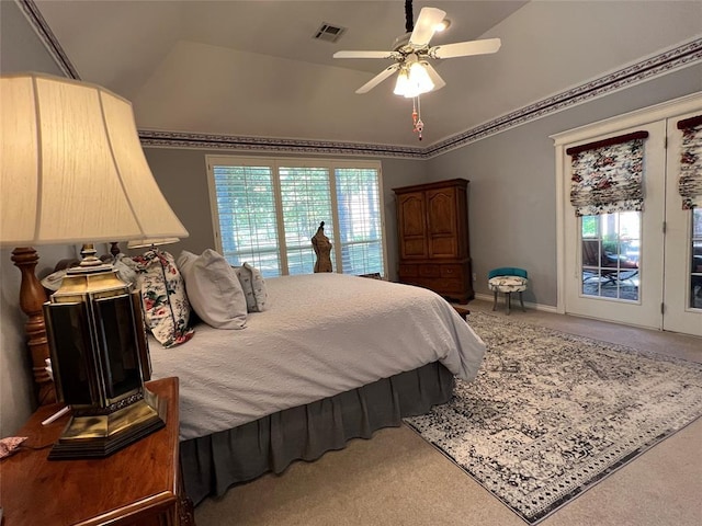 carpeted bedroom featuring lofted ceiling, multiple windows, and visible vents