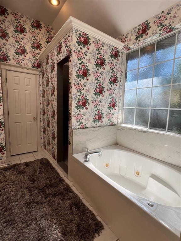 bathroom with a whirlpool tub, wallpapered walls, and tile patterned floors