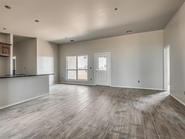 unfurnished living room featuring light wood-type flooring