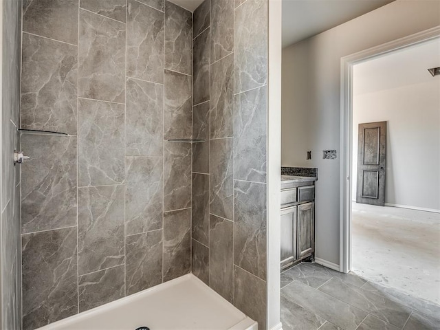 bathroom featuring vanity and a tile shower