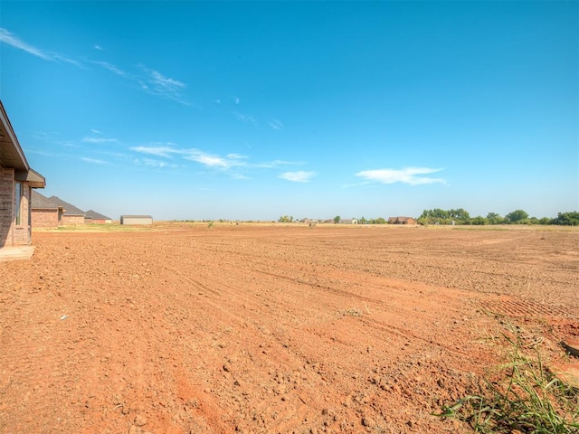 view of yard with a rural view