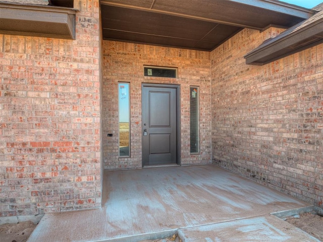 entrance to property with brick siding