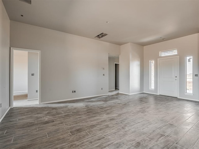 interior space featuring baseboards and wood finished floors