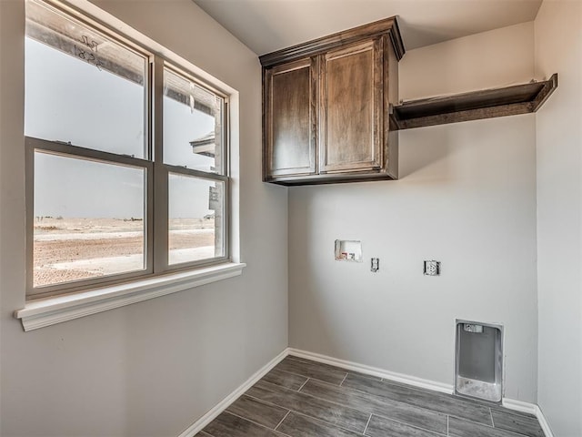 laundry room with dark wood-style floors, cabinet space, baseboards, and hookup for a washing machine
