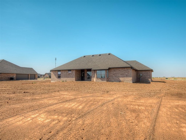 back of house featuring brick siding