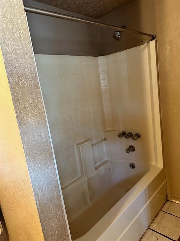 bathroom with tiled shower / bath combo and tile patterned floors