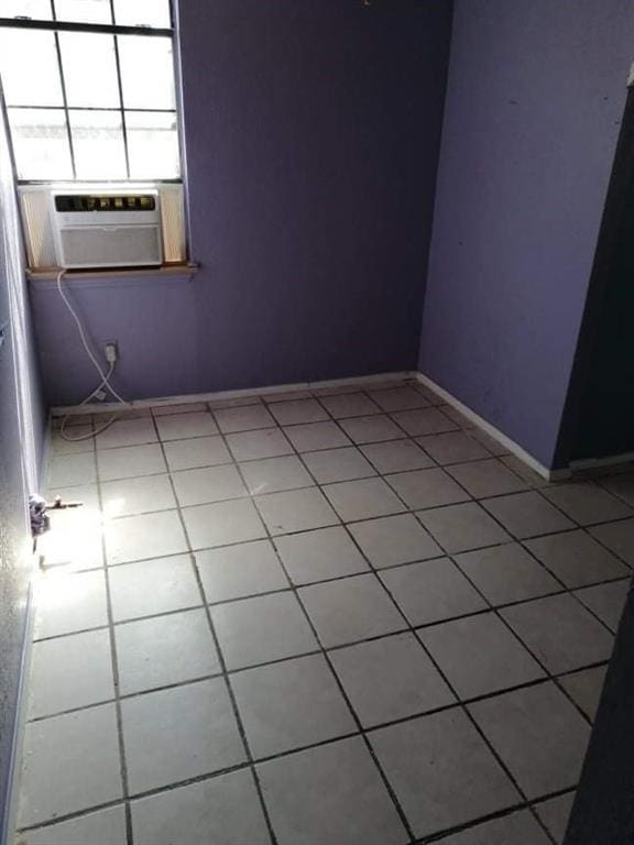 empty room featuring tile patterned floors and cooling unit