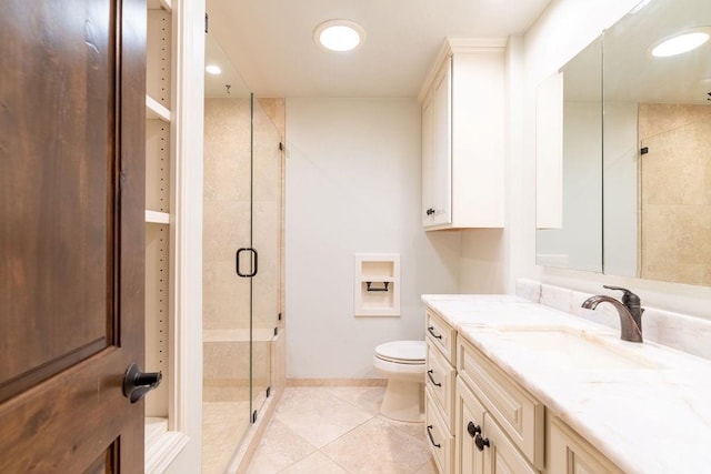 bathroom with toilet, vanity, tile patterned floors, and a shower with shower door