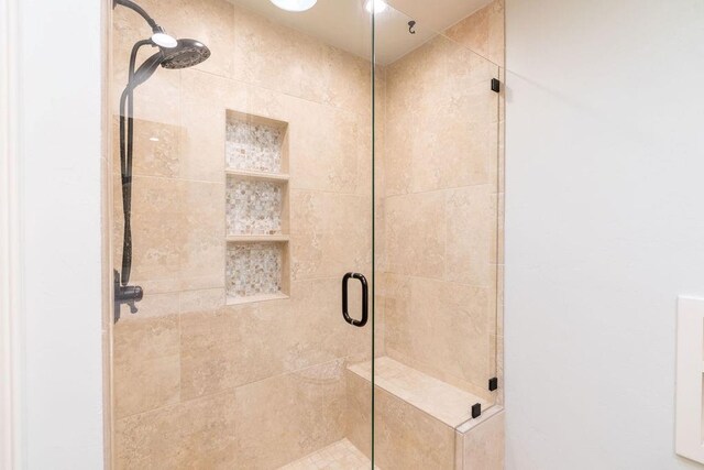 bathroom with a shower with shower door