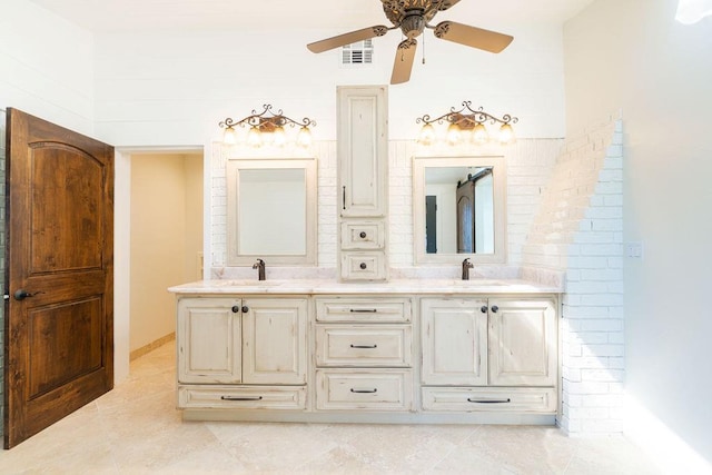 bathroom with tile patterned flooring, vanity, and ceiling fan