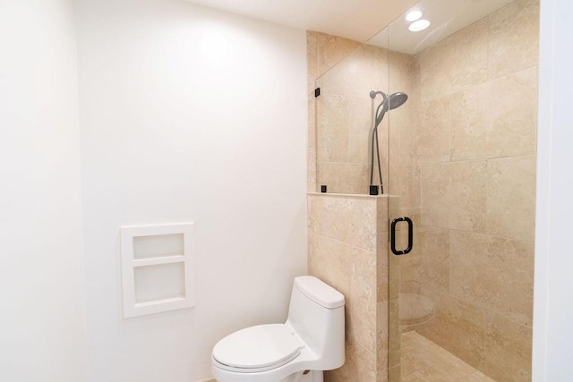 bathroom featuring toilet and an enclosed shower