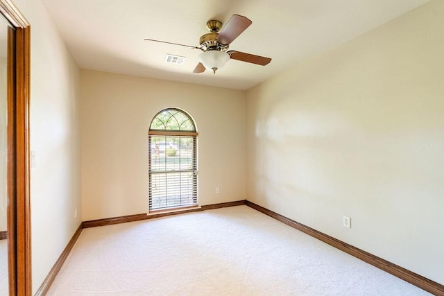 carpeted spare room featuring ceiling fan