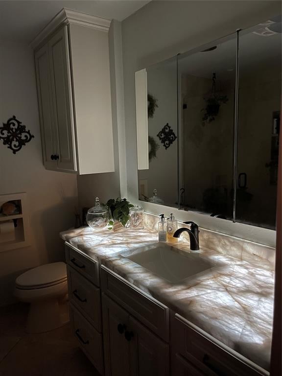 bathroom with tile patterned floors, vanity, and toilet