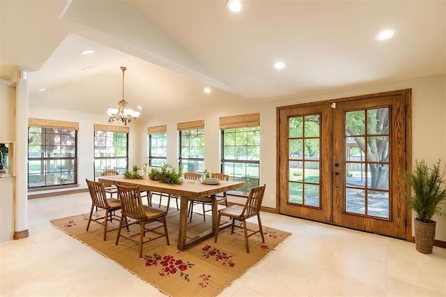 dining space with french doors, an inviting chandelier, and lofted ceiling