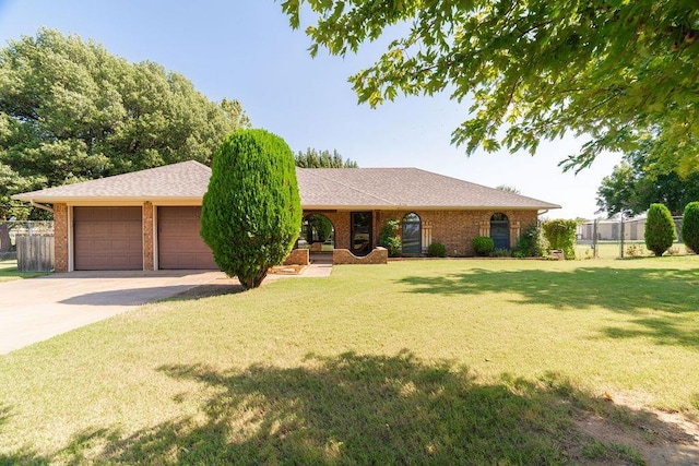 ranch-style house with a garage and a front lawn