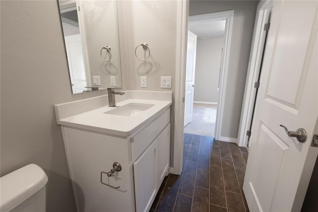 bathroom featuring vanity and toilet