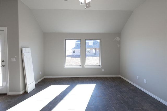 unfurnished room with ceiling fan, dark hardwood / wood-style flooring, and vaulted ceiling