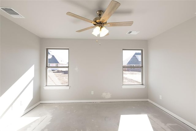 empty room featuring a wealth of natural light and ceiling fan