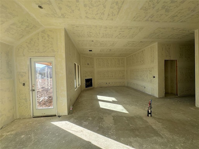 unfurnished living room with lofted ceiling