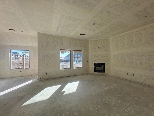 unfurnished living room featuring plenty of natural light and a premium fireplace