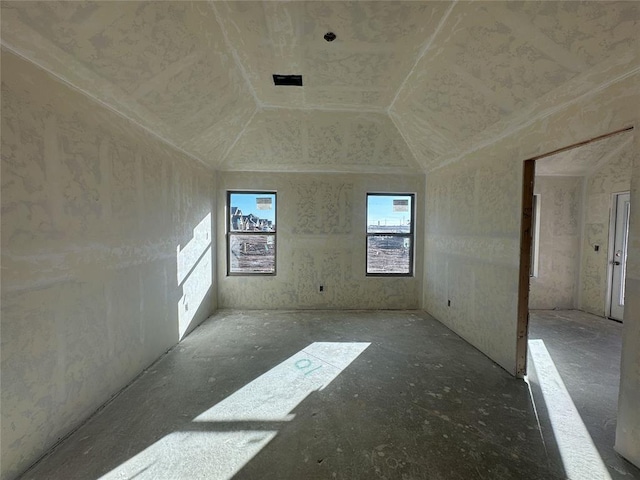 empty room with vaulted ceiling