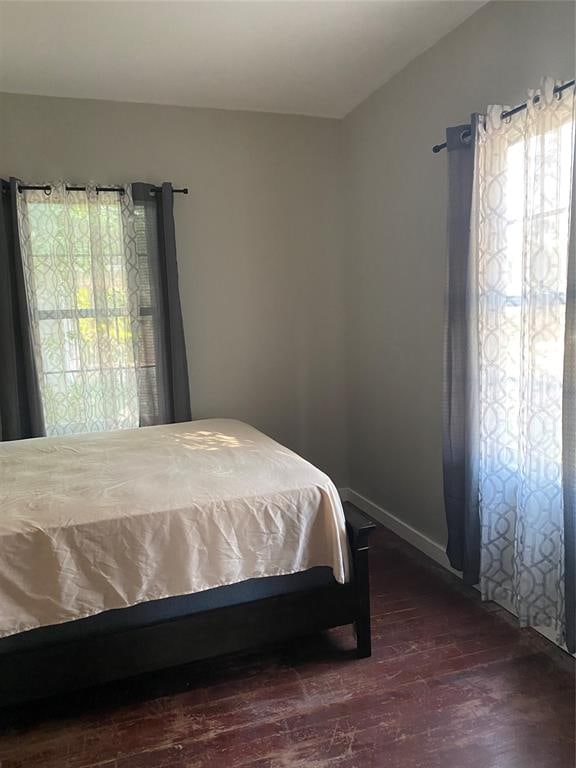 bedroom with dark hardwood / wood-style floors