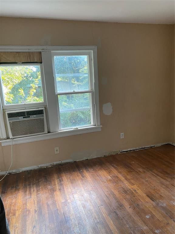 spare room featuring dark hardwood / wood-style floors and cooling unit