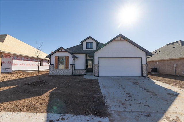 view of front of home featuring central AC unit and a garage