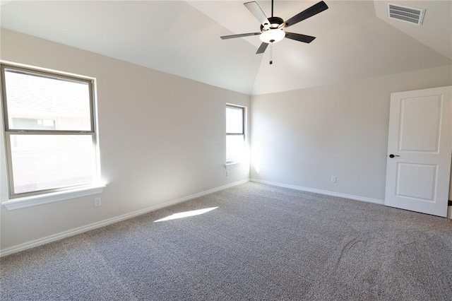 empty room featuring ceiling fan, carpet floors, and vaulted ceiling