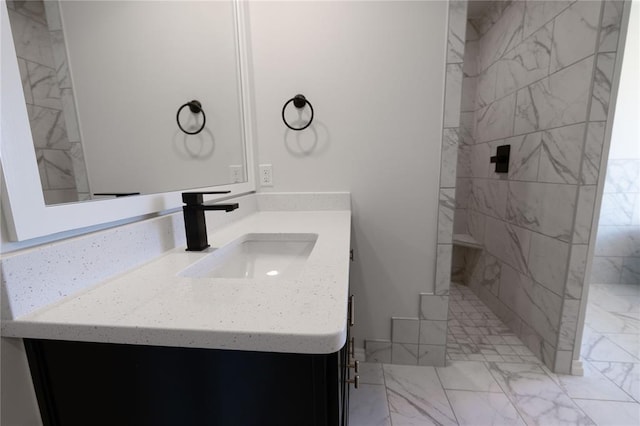 bathroom featuring vanity and a tile shower