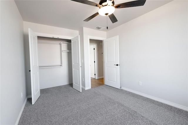 unfurnished bedroom with carpet floors, ceiling fan, and a closet