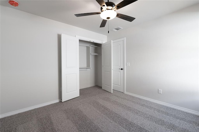 unfurnished bedroom with a closet, ceiling fan, and carpet flooring