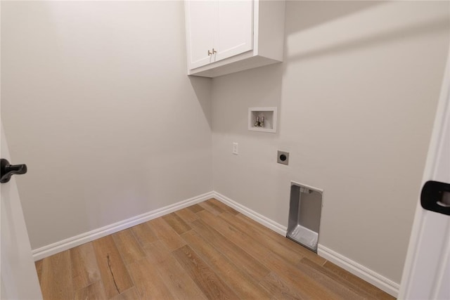 washroom with cabinets, hookup for an electric dryer, hookup for a washing machine, and light hardwood / wood-style flooring