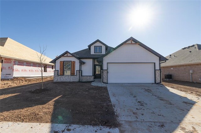 view of front of home featuring a garage and central AC unit