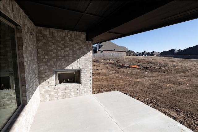 view of patio / terrace featuring an outdoor brick fireplace