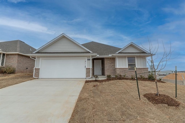 single story home with a garage, concrete driveway, a shingled roof, and brick siding