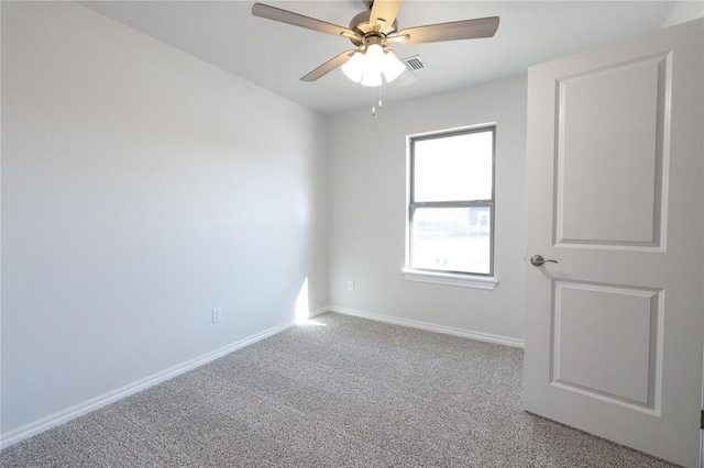 carpeted spare room with a ceiling fan, baseboards, and visible vents