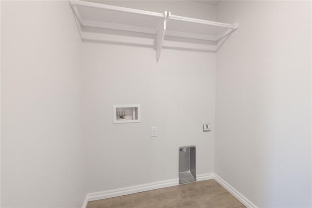 clothes washing area with baseboards, washer hookup, laundry area, and electric dryer hookup