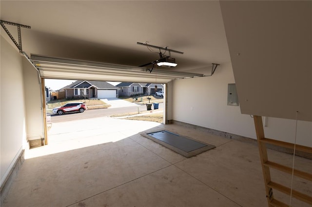 garage with electric panel and a garage door opener