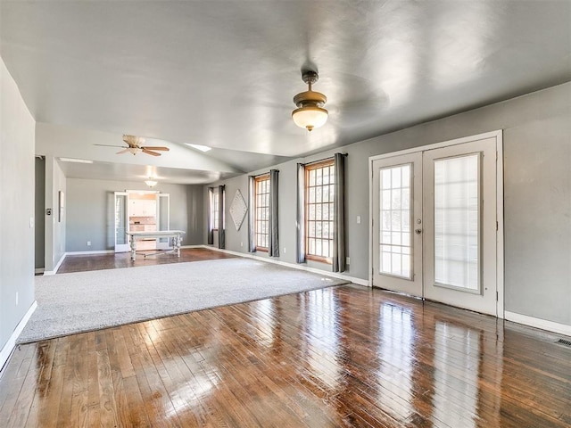 unfurnished living room with hardwood / wood-style flooring, ceiling fan, and french doors