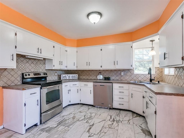 kitchen with sink, white cabinetry, stainless steel appliances, and hanging light fixtures