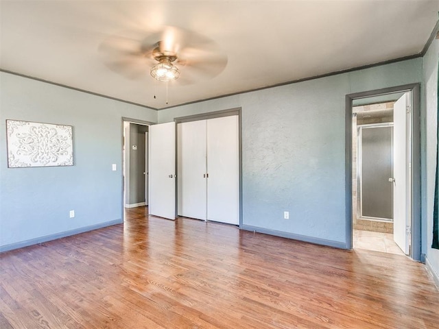 unfurnished bedroom with ceiling fan and light hardwood / wood-style floors