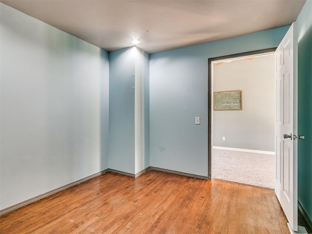 spare room featuring light hardwood / wood-style floors