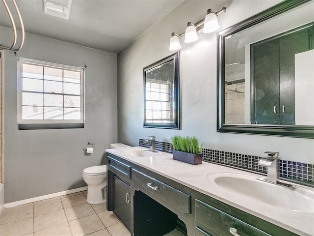 full bathroom with a wealth of natural light, tile patterned flooring, vanity, and toilet