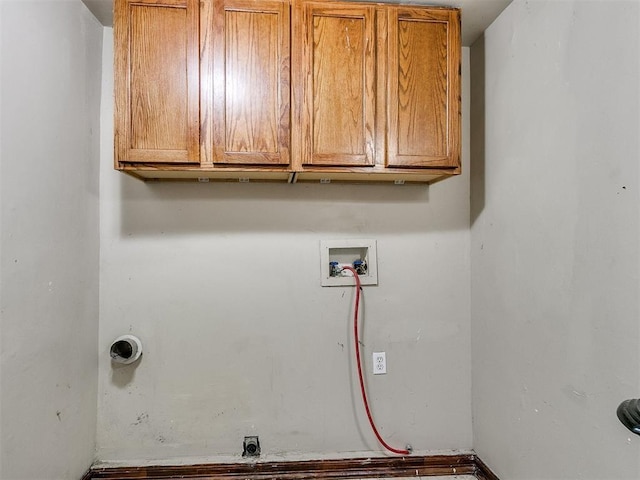 laundry room with hookup for a washing machine and cabinets